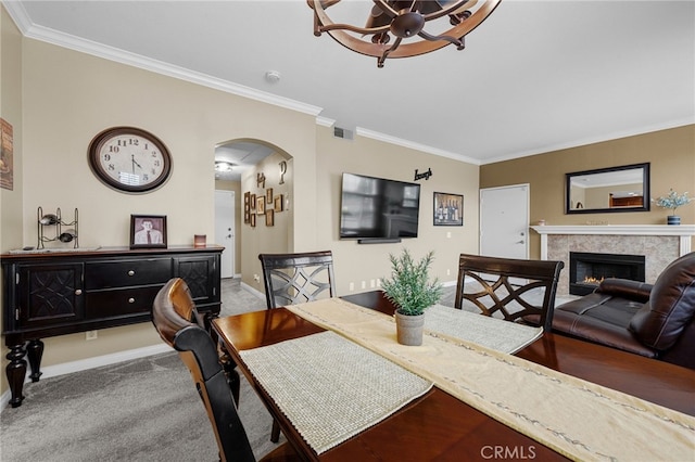 23412 Pacific Park Dr Unit 40H, Aliso Viejo, CA 92656 - dining area featuring arched walkways, baseboards, a lit fireplace, ornamental molding, and carpet