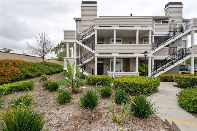 23412 Pacific Park Dr Unit 40H, Aliso Viejo, CA 92656 - back of property featuring stairs and a chimney