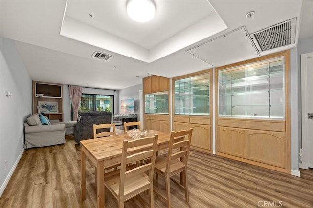 321 N Orange Unit 104, Monterey Park, CA 91755 - dining area with a tray ceiling, light wood-style flooring, and visible vents