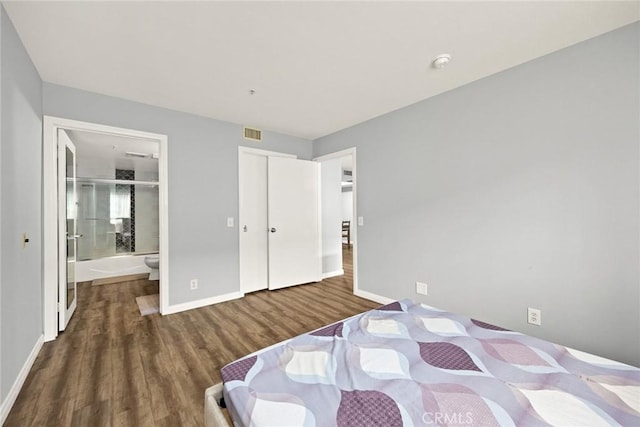 321 N Orange Unit 104, Monterey Park, CA 91755 - bedroom featuring connected bathroom, baseboards, visible vents, and wood finished floors