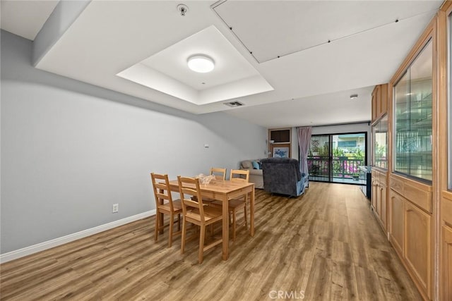 321 N Orange Unit 104, Monterey Park, CA 91755 - dining area featuring a tray ceiling, baseboards, light wood-style flooring, and visible vents
