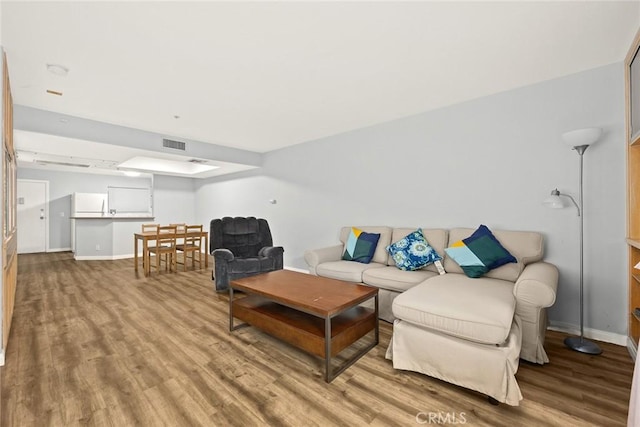 321 N Orange Unit 104, Monterey Park, CA 91755 - living area featuring baseboards, visible vents, and wood finished floors
