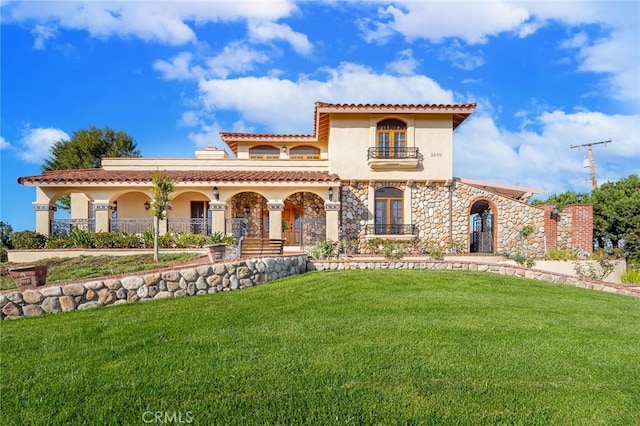 2240 Foothill Blvd, Santa Ana, CA 92705 - mediterranean / spanish house with a balcony, a front yard, a porch, and stucco siding