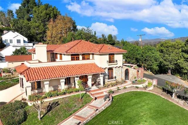 2240 Foothill Blvd, Santa Ana, CA 92705 - mediterranean / spanish-style house with a porch, stone siding, a tile roof, stucco siding, and a front lawn