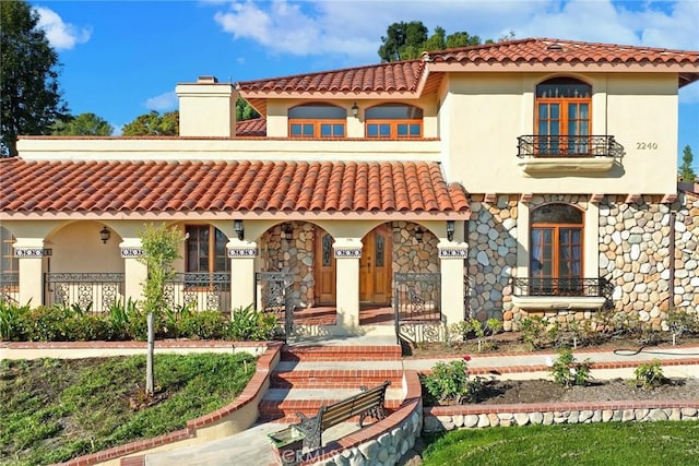 2240 Foothill Blvd, Santa Ana, CA 92705 - mediterranean / spanish-style home featuring a porch, a tiled roof, and a chimney