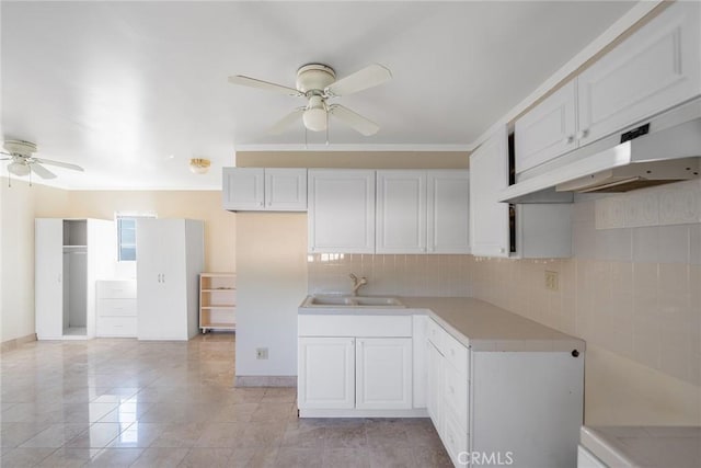 2240 Foothill Blvd, Santa Ana, CA 92705 - kitchen featuring a ceiling fan, under cabinet range hood, a sink, light countertops, and tasteful backsplash