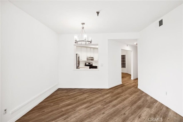 1450 Brett Pl Unit 205, San Pedro, CA 90732 - unfurnished dining area featuring an inviting chandelier, visible vents, wood finished floors, and baseboards