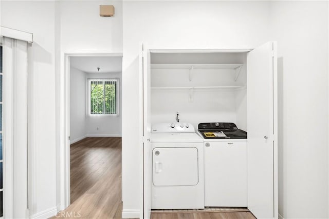 1450 Brett Pl Unit 205, San Pedro, CA 90732 - laundry room with washer and clothes dryer, light wood-style flooring, and baseboards