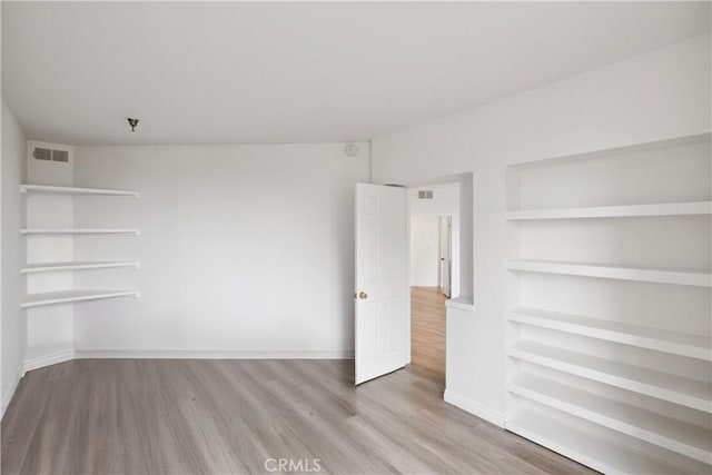 1450 Brett Pl Unit 205, San Pedro, CA 90732 - unfurnished room with wood finished floors, built in features, and fire sprinkler in ceiling