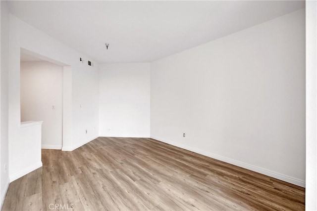 1450 Brett Pl Unit 205, San Pedro, CA 90732 - spare room with wood finished floors, baseboards, and fire sprinkler in ceiling