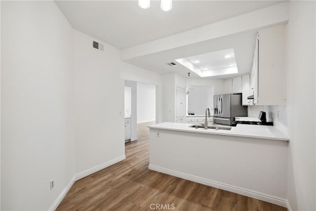1450 Brett Pl Unit 205, San Pedro, CA 90732 - kitchen featuring stainless steel fridge with ice dispenser, range, a raised ceiling, wood finished floors, and light countertops