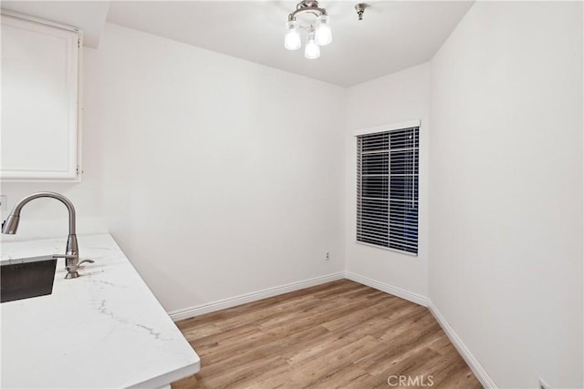 1450 Brett Pl Unit 205, San Pedro, CA 90732 - unfurnished dining area featuring light wood-type flooring, baseboards, and a sink