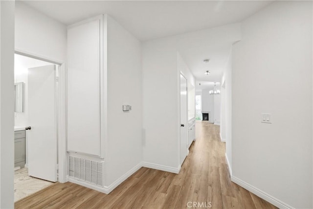 1450 Brett Pl Unit 205, San Pedro, CA 90732 - hall with light wood-type flooring and a chandelier