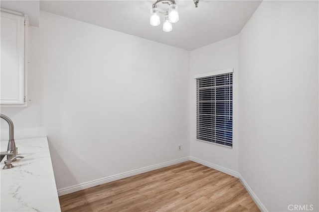 1450 Brett Pl Unit 205, San Pedro, CA 90732 - unfurnished dining area with light wood-style floors and baseboards