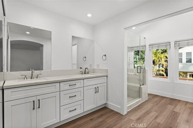 16 Encina, Irvine, CA 92620 - bathroom featuring a sink, baseboards, and wood finished floors