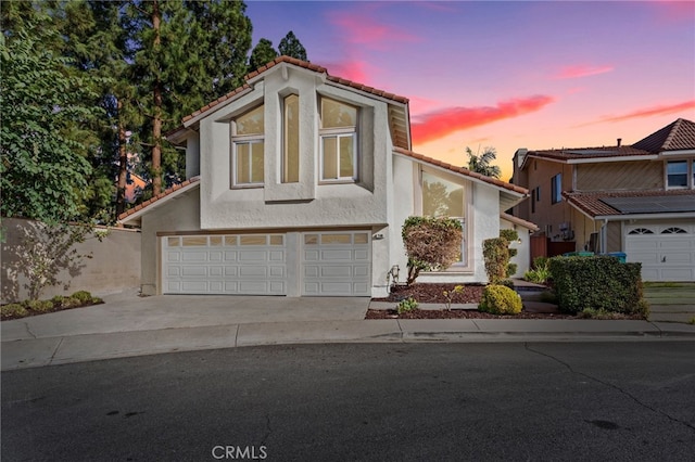 16 Encina, Irvine, CA 92620 - view of front of property featuring stucco siding, a garage, a tiled roof, and driveway