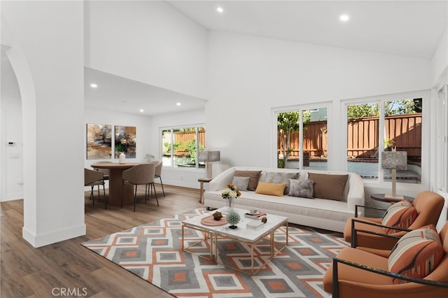 16 Encina, Irvine, CA 92620 - living room featuring arched walkways, high vaulted ceiling, recessed lighting, and wood finished floors
