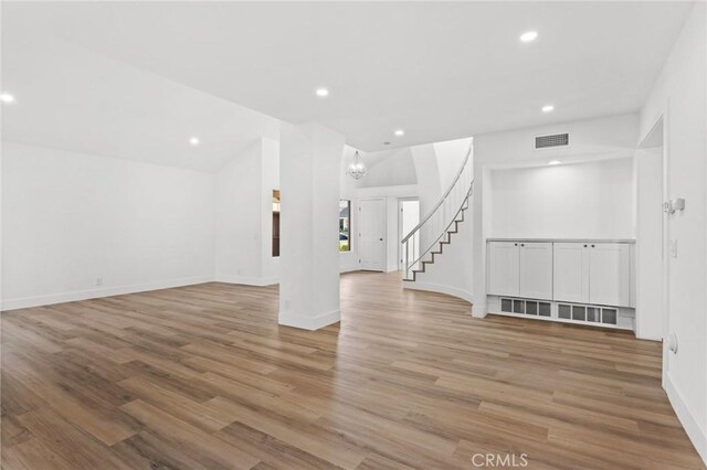 16 Encina, Irvine, CA 92620 - unfurnished room with recessed lighting, stairway, visible vents, and wood finished floors