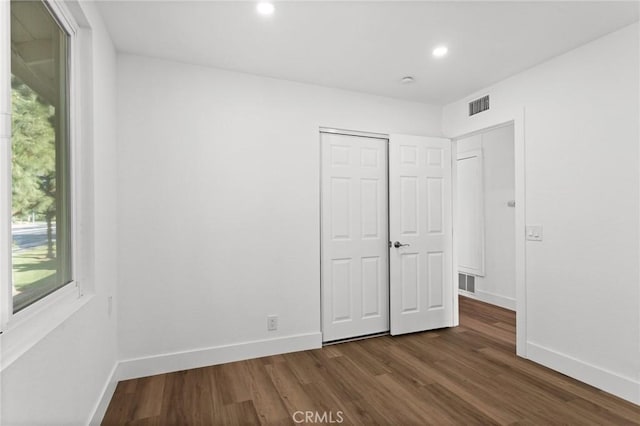 16 Encina, Irvine, CA 92620 - unfurnished bedroom with dark wood finished floors, visible vents, baseboards, and recessed lighting