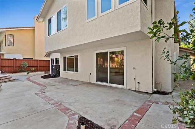 16 Encina, Irvine, CA 92620 - back of property featuring central air condition unit, stucco siding, fence, and a patio area