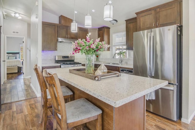 3465 Barrett Vw, Alpine, CA 91901 - kitchen featuring appliances with stainless steel finishes, a sink, decorative backsplash, under cabinet range hood, and light wood-style floors