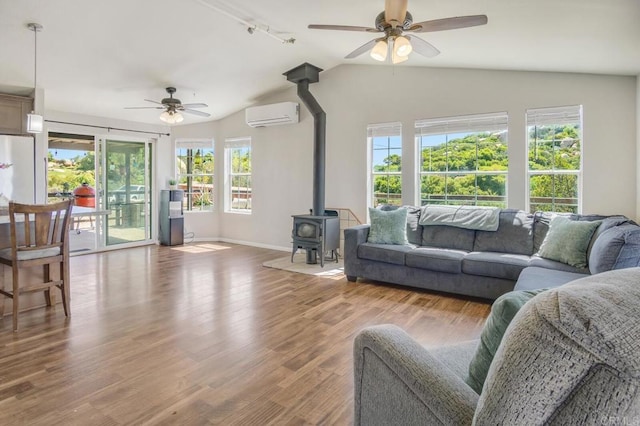 3465 Barrett Vw, Alpine, CA 91901 - living area with ceiling fan, a wall mounted air conditioner, a wood stove, vaulted ceiling, and wood finished floors