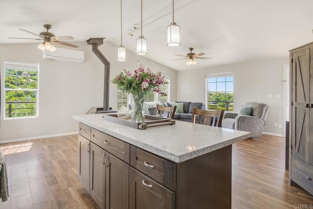 3465 Barrett Vw, Alpine, CA 91901 - kitchen with a ceiling fan, an AC wall unit, wood finished floors, a kitchen island, and dark brown cabinetry