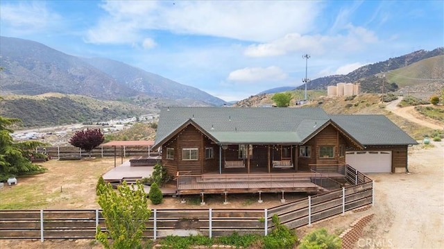 770 Roads End, Lebec, CA 93243 - rear view of property featuring fence, a garage, a mountain view, and driveway