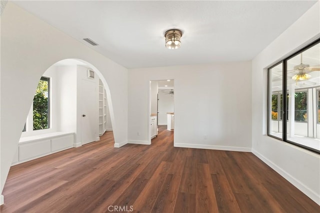2918 Los Campos Dr, Fallbrook, CA 92028 - empty room with wood finished floors, arched walkways, and baseboards