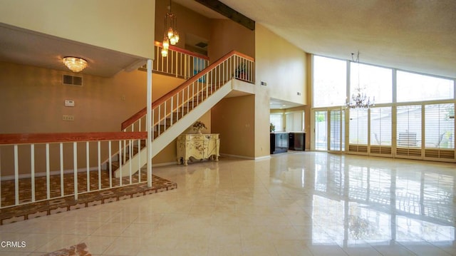 7816 Quartz Ave, Los Angeles, CA 91306 - unfurnished living room featuring a chandelier, a towering ceiling, stairway, a wall of windows, and baseboards
