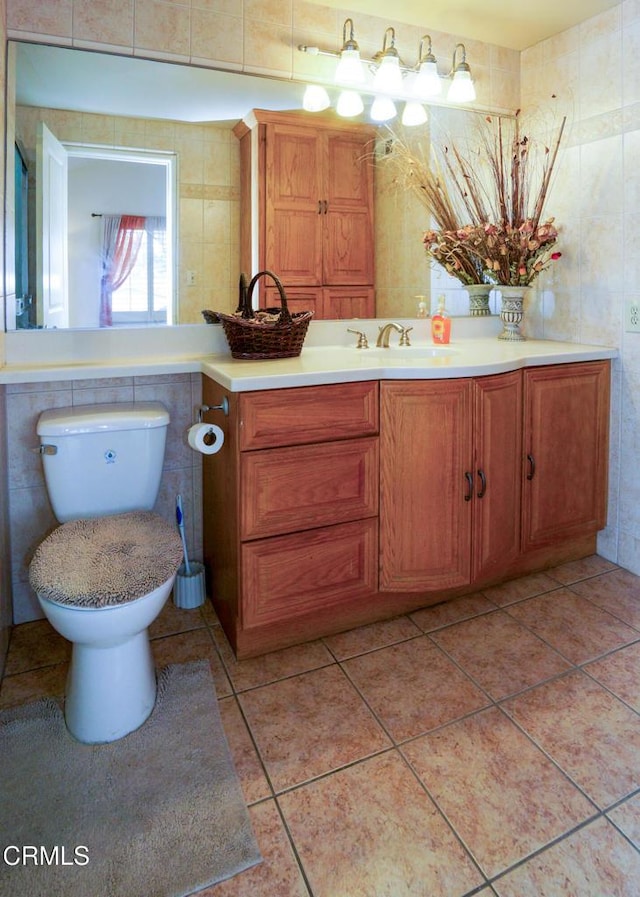 7816 Quartz Ave, Los Angeles, CA 91306 - bathroom featuring tile walls, toilet, vanity, and tile patterned flooring