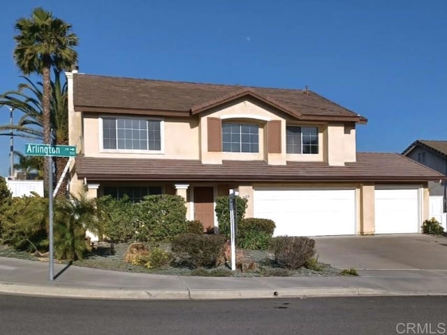 308 Arlington Dr, Oceanside, CA 92057 - view of front of home with concrete driveway, stucco siding, and an attached garage