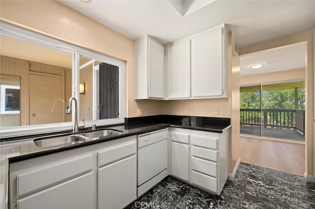 kitchen featuring white cabinets, a sink, and white dishwasher
