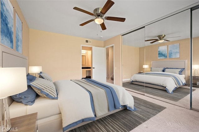 carpeted bedroom with ceiling fan, a closet, and visible vents