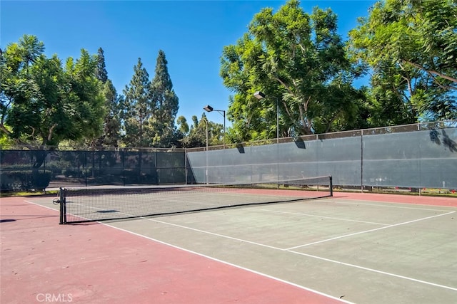 view of tennis court with fence