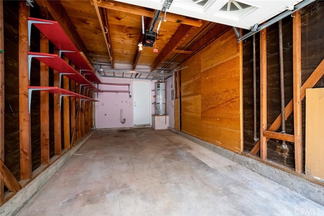 garage with secured water heater and a garage door opener