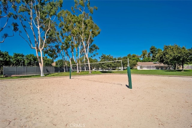 view of community with fence and volleyball court