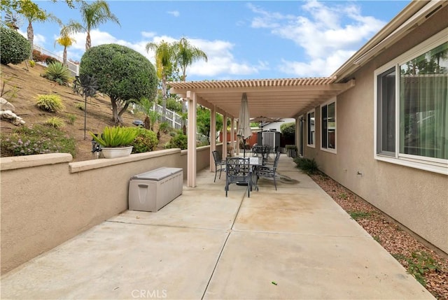 view of patio / terrace with a storage unit, a pergola, outdoor dining area, an outdoor structure, and a fenced backyard