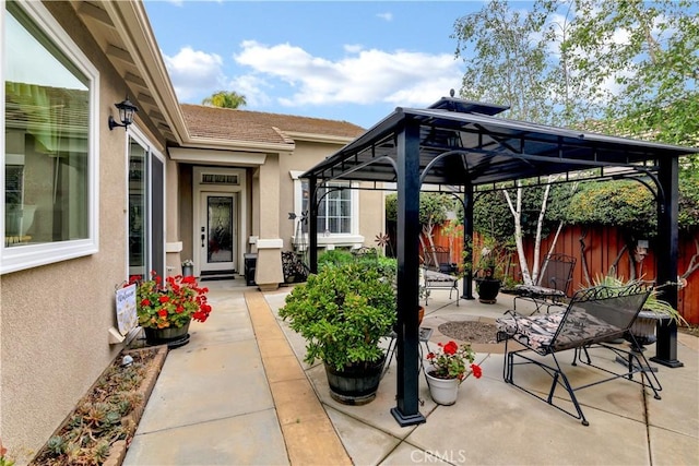 view of patio featuring a gazebo and fence