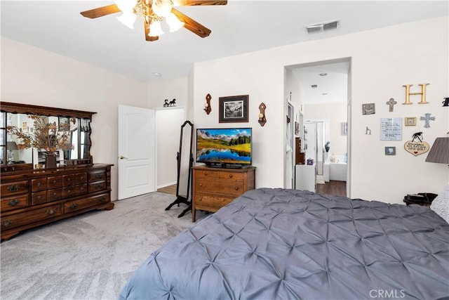 carpeted bedroom with a ceiling fan, connected bathroom, and visible vents