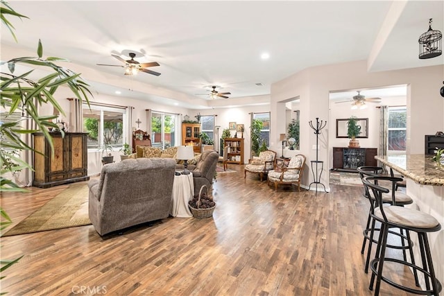 living area featuring recessed lighting, a ceiling fan, and wood finished floors