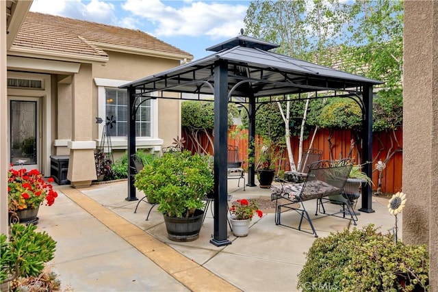 view of patio with a gazebo and fence