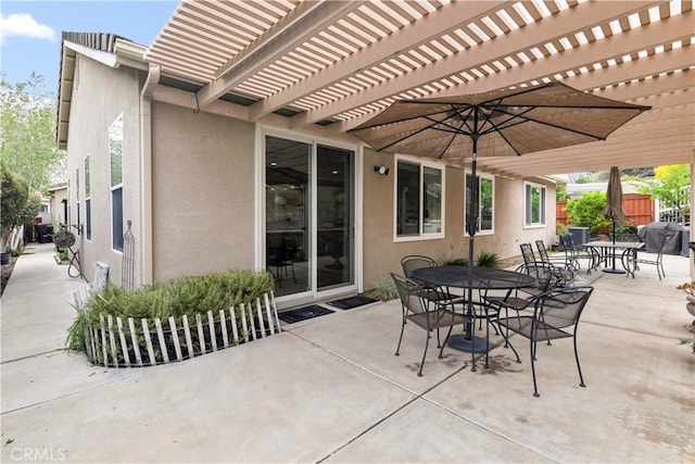 view of patio / terrace with a pergola, fence, and outdoor dining space