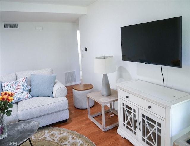 living area featuring visible vents and light wood-style flooring