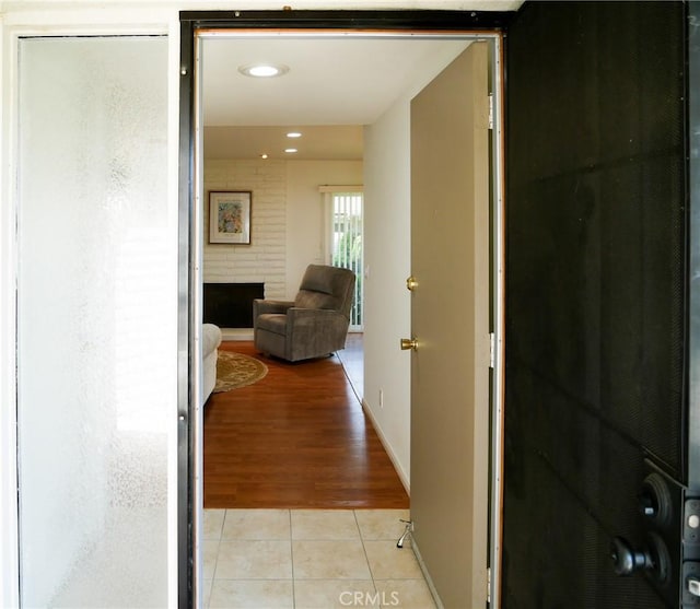 hallway with light tile patterned floors, baseboards, and recessed lighting