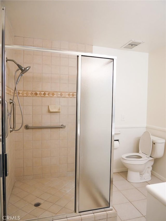 full bath with toilet, visible vents, tile patterned flooring, and a shower stall