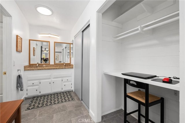27071 Calle Caballero Unit B, San Juan Capistrano, CA 92675 - bathroom with vanity, baseboards, and stone finish floors