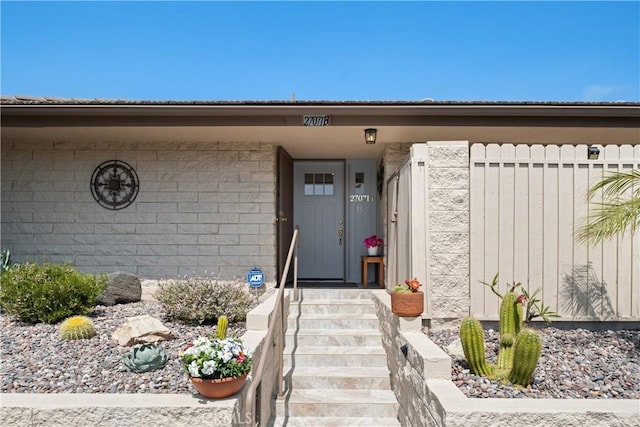doorway to property with fence