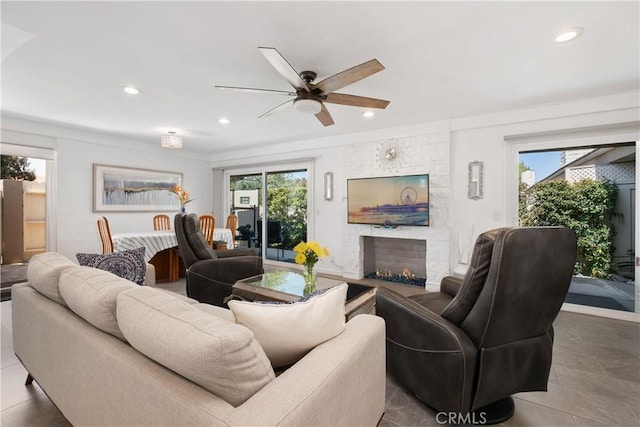 living area with a fireplace, ceiling fan, plenty of natural light, and recessed lighting