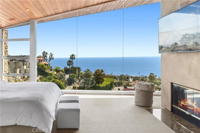 856 Diamond, Laguna Beach, CA 92651 - bedroom featuring wood ceiling, a fireplace with flush hearth, expansive windows, and a water view